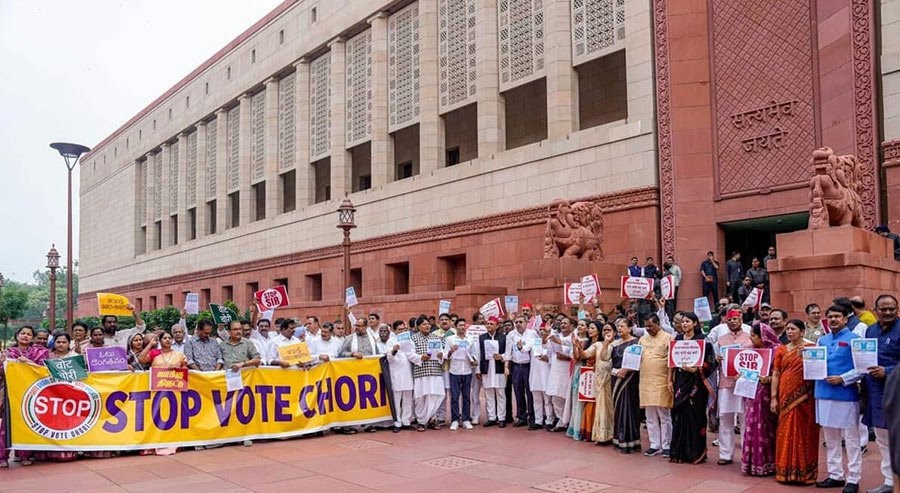 Protestors holding “Stop vote chori” banners during Bihar SIR protests outside Indian Parliament