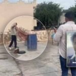 Police officers working at the scene in Tijara where a blue drum containing a body was found.