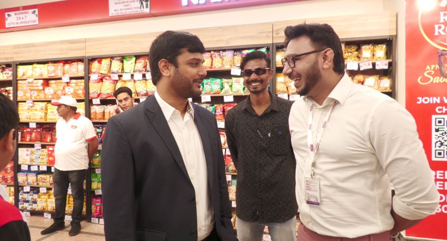 Inside shot from Red Rose Mart inauguration event showing two attendees in conversation.